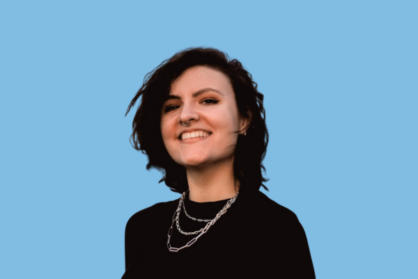 Black and white portrait of a dance instructor against a light background.