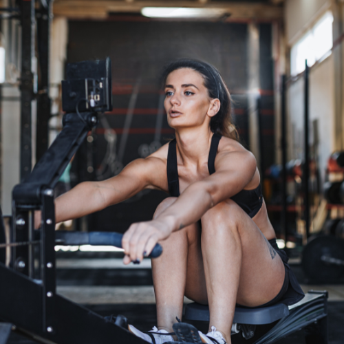 Photo of a silhouette of 2 dancers posing in front of a red curtain.